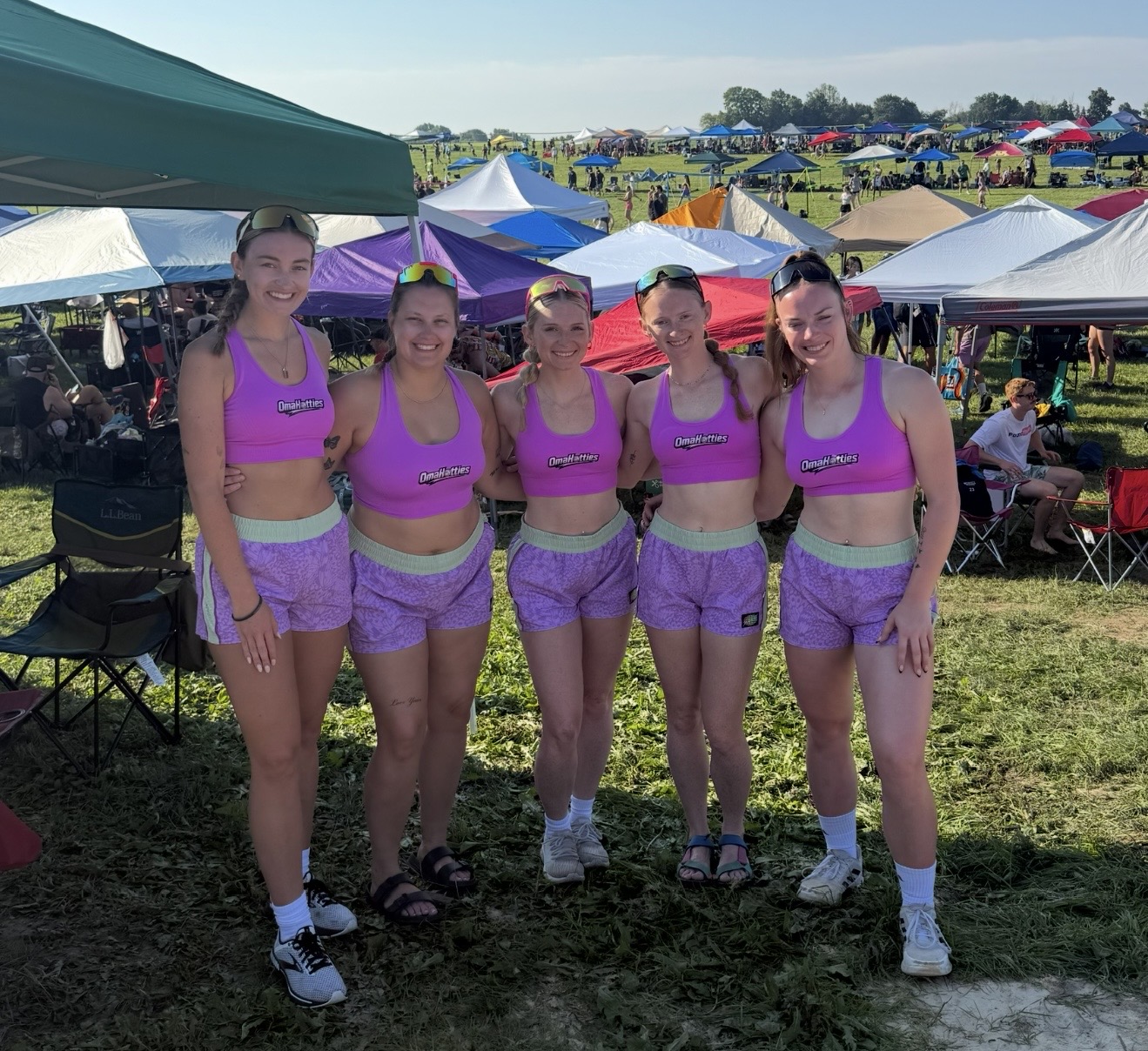 Omahotties in pink and purple kits at a grass tournament