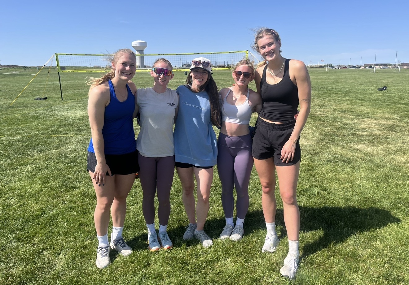 Omahotties teammates on the grass courts on a sunny day